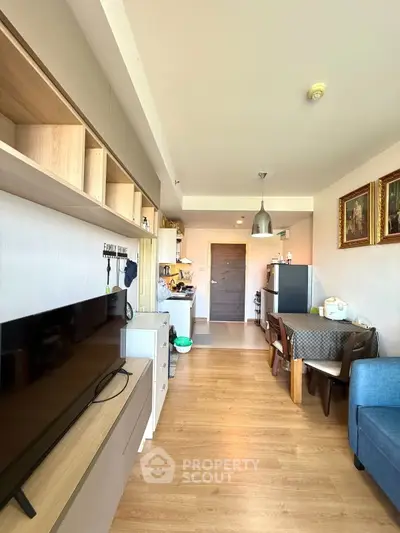 Modern open-plan living room with stylish decor and wooden flooring