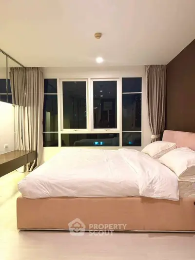 Luxurious bedroom with large windows and elegant decor in modern apartment