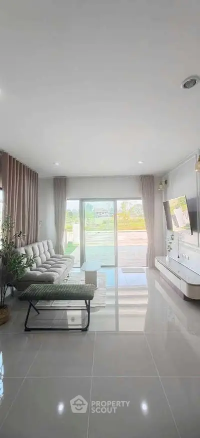 Spacious modern living room with large windows and elegant decor