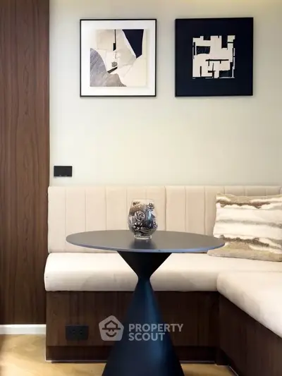 Stylish modern living room with elegant wall art and cozy seating area.