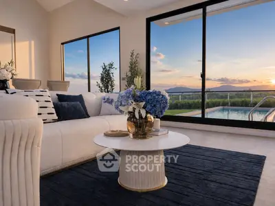 Luxurious living room with stunning sunset view and pool access, featuring elegant decor and large glass doors.