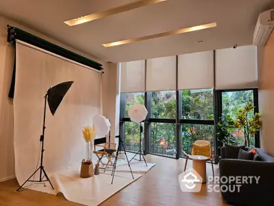 Spacious modern living room with large windows and stylish decor, perfect for photography studio setup.