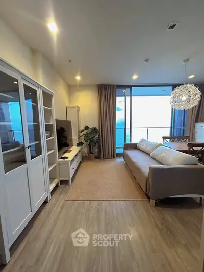 Spacious living room with modern decor and stunning ocean view from large windows.