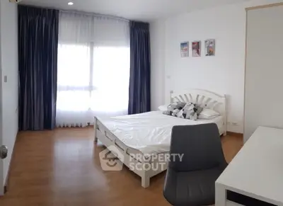 Spacious bedroom with modern decor and ample natural light
