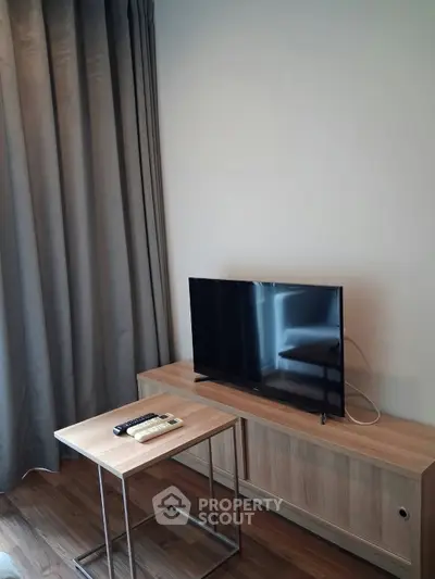 Modern living room with sleek TV setup and stylish wooden furniture