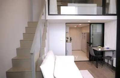 Modern loft apartment with stylish staircase and open kitchen layout