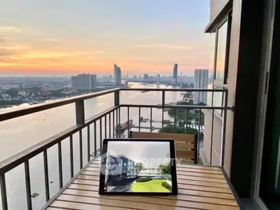 Stunning river view from a high-rise balcony at sunset, perfect for relaxation.