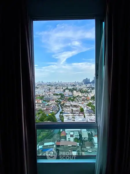 Stunning cityscape view from high-rise window showcasing urban skyline.