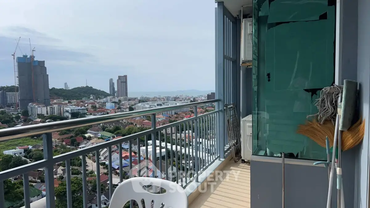 Stunning balcony view overlooking cityscape and distant hills, perfect for relaxation.