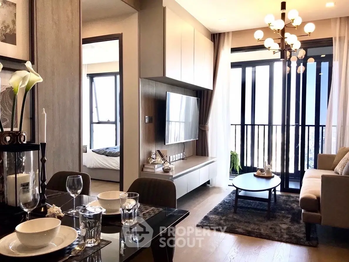 Modern living room with elegant decor and large windows offering stunning city views.