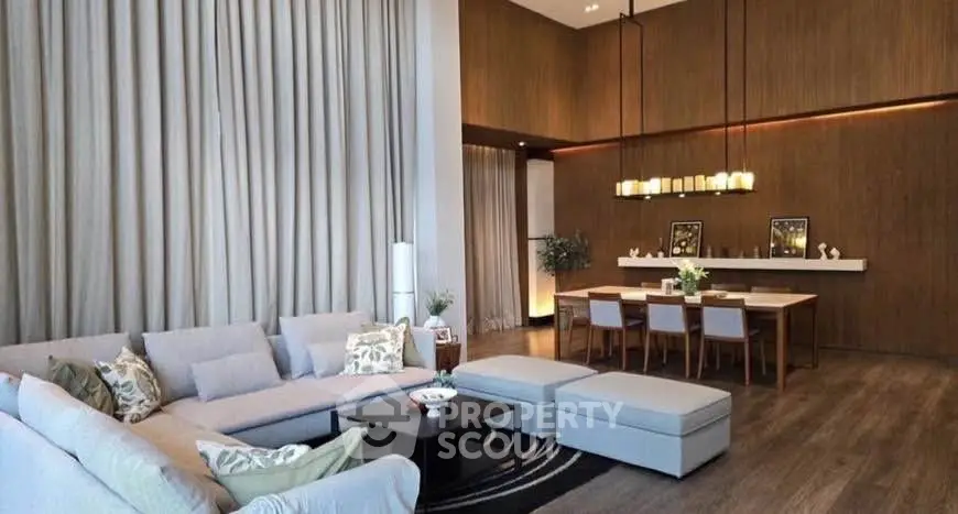 Luxurious living room with high ceilings and elegant dining area, perfect for entertaining.