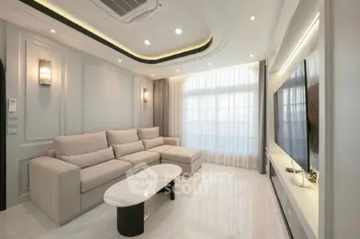 Luxurious modern living room with elegant sofa and large TV, featuring stylish lighting and sleek design.