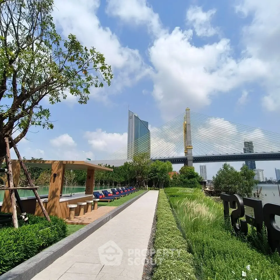 Luxurious riverside garden with modern architecture and stunning bridge view, perfect for relaxation and leisure.