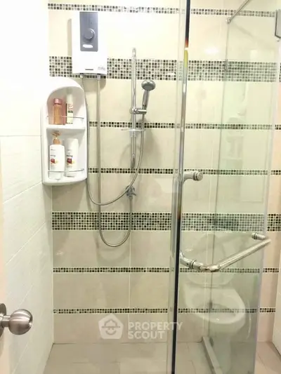 Modern bathroom with glass shower enclosure and sleek tile design