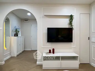 Modern living room with wall-mounted TV and stylish decor