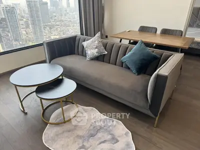 Modern living room with stylish sofa and city view, perfect for urban living.