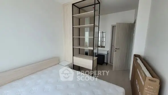 Modern bedroom with minimalist design and ample natural light.