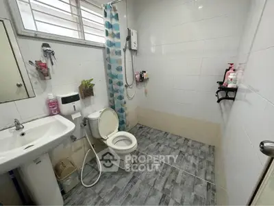 Spacious bathroom with modern fixtures and stylish tile flooring