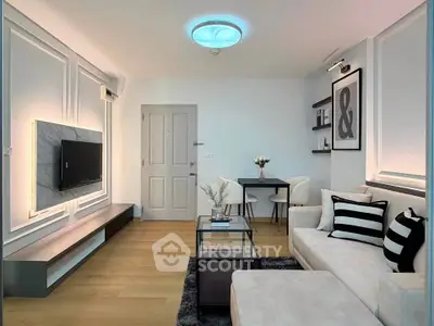 Modern living room with stylish decor, cozy seating, and elegant lighting in a contemporary apartment.