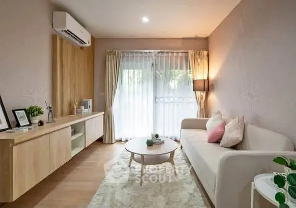 Modern living room with stylish decor and natural light, featuring a cozy sofa and elegant furnishings.