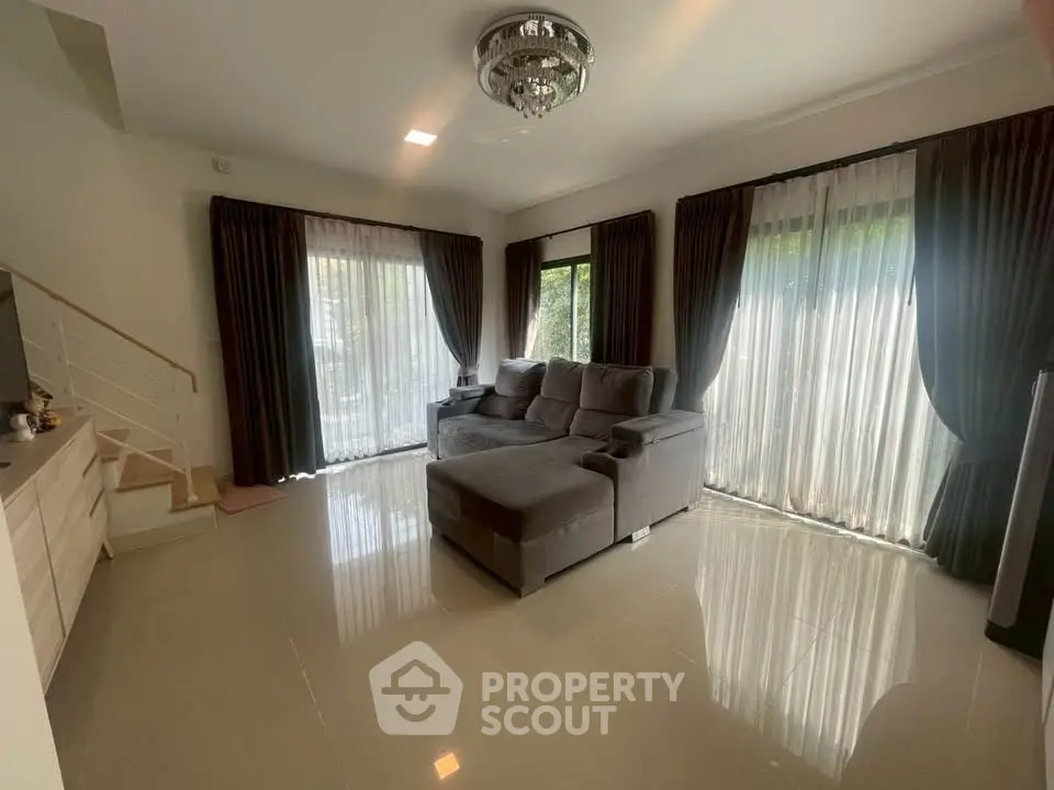 Spacious living room with elegant decor and large windows for natural light.