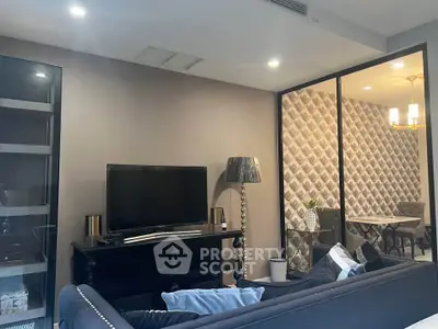 Stylish living room with modern decor and adjacent dining area in a chic apartment.