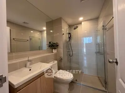 Modern bathroom with sleek fixtures and glass shower enclosure