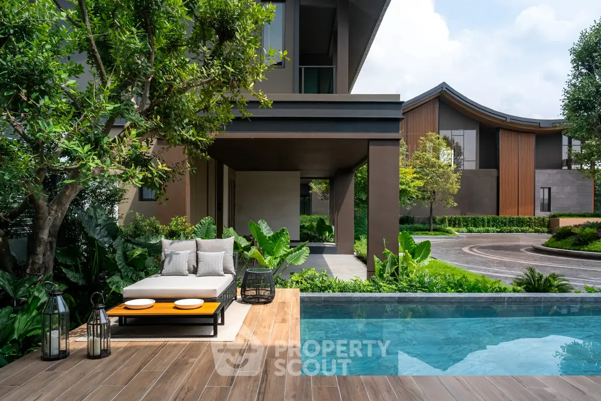 Luxurious modern home with pool and lush garden, perfect for relaxation and entertaining.