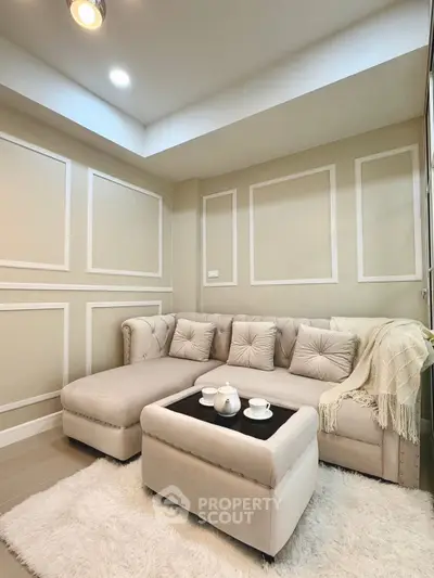 Elegant living room with plush beige sofa and chic decor