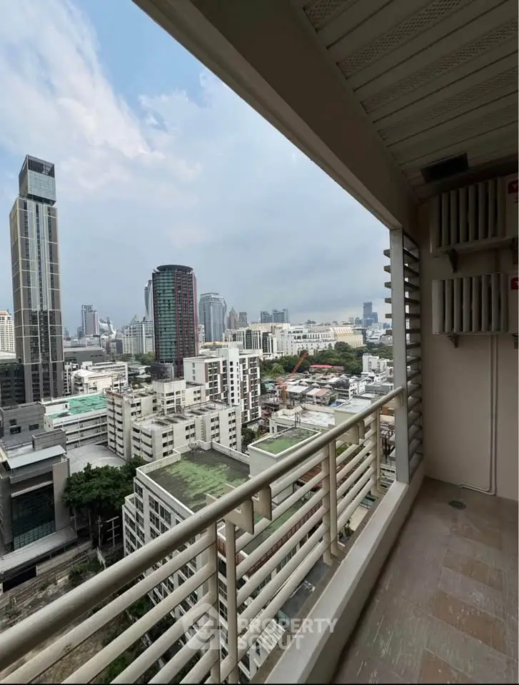 Stunning cityscape view from a high-rise balcony, showcasing urban skyline and modern architecture.