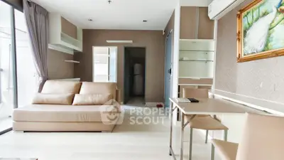 Modern living room with beige sofa, sleek dining area, and stylish decor in a contemporary apartment.
