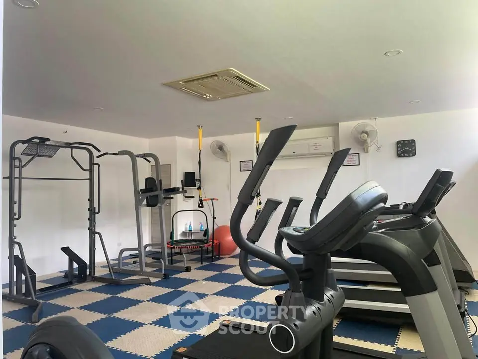 Modern gym with exercise equipment in a residential building