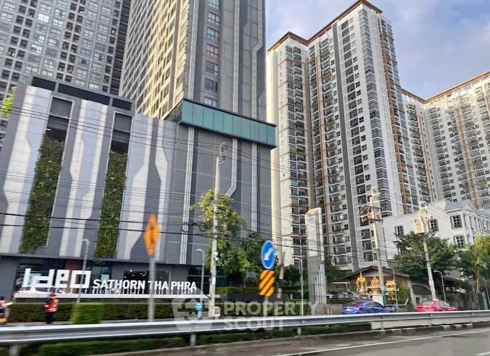 Modern high-rise residential buildings with lush greenery and urban surroundings.