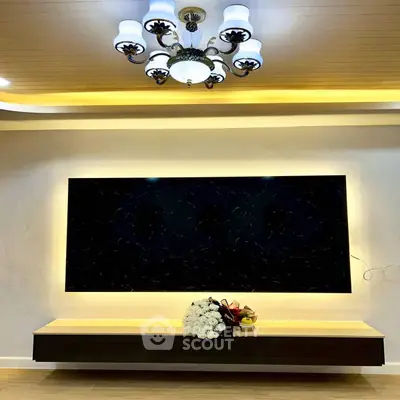 Elegant living room with modern chandelier and sleek TV setup