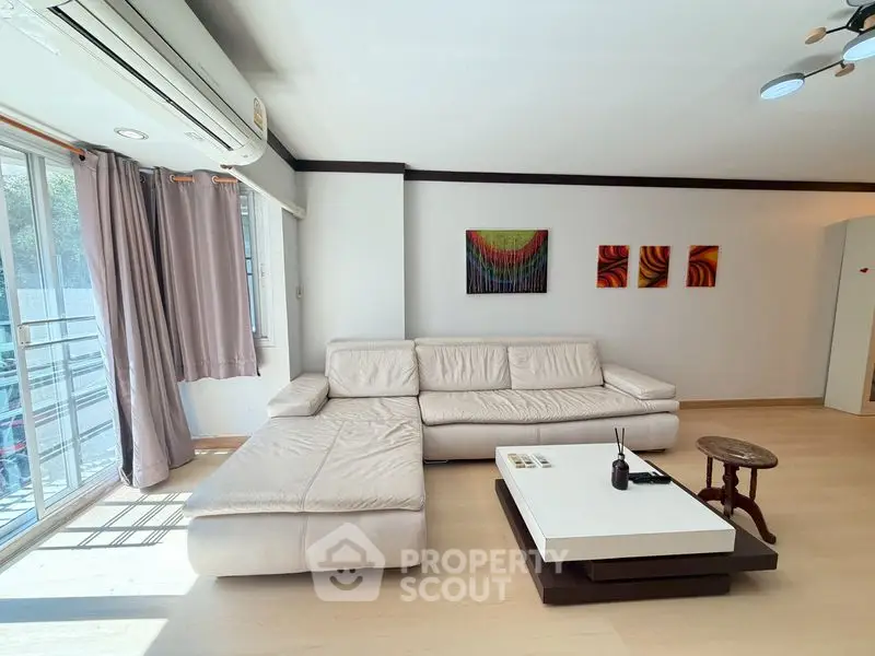 Spacious living room with modern decor and natural light