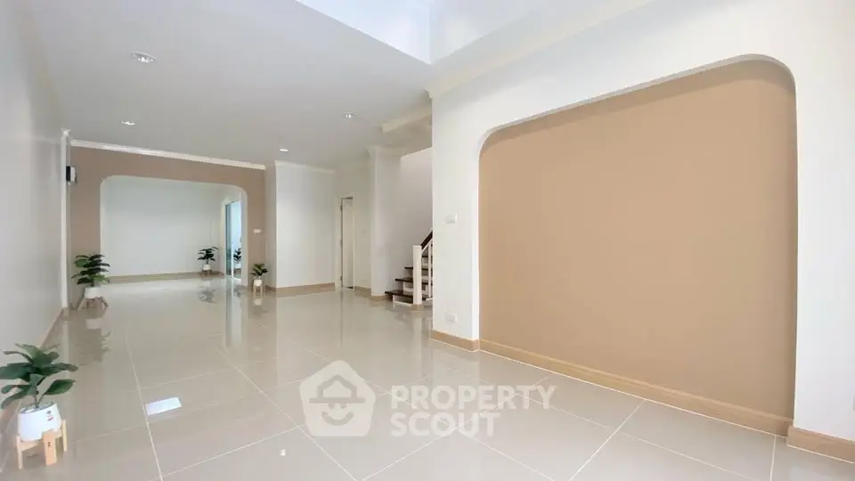 Spacious modern living room with elegant tile flooring and neutral tones