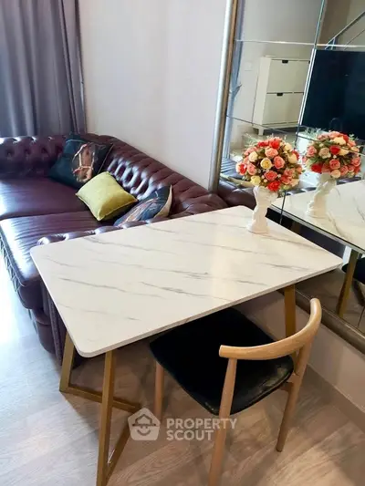 Stylish living room with elegant marble table and plush leather sofa, perfect for modern urban living.