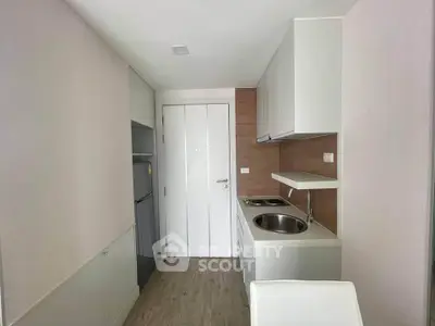 Modern compact kitchen with sleek cabinetry and integrated appliances