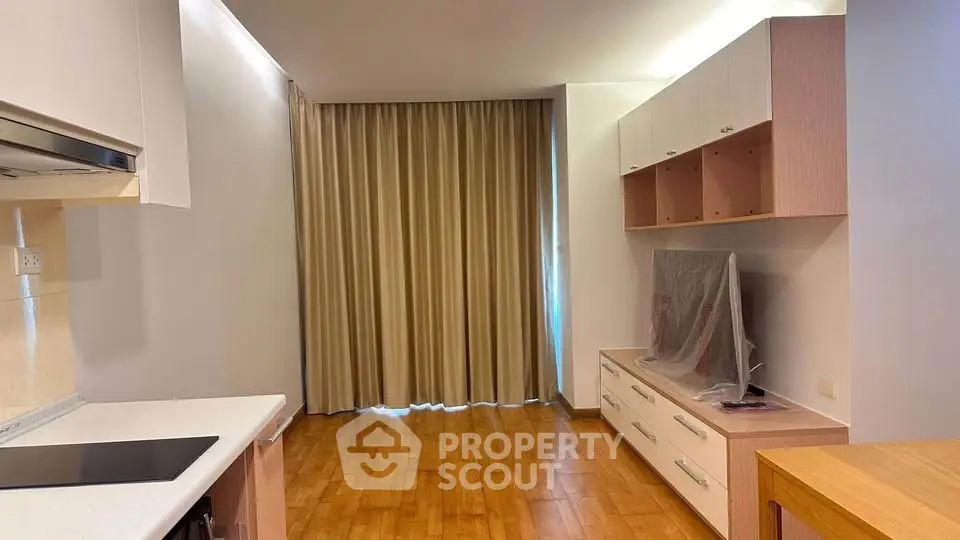 Modern living room with wooden flooring and built-in storage cabinets