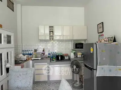 Charming kitchen with modern appliances and sleek cabinetry, perfect for culinary enthusiasts.