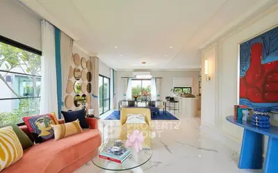 Luxurious modern living room with vibrant decor and open layout, featuring elegant furnishings and artistic touches.