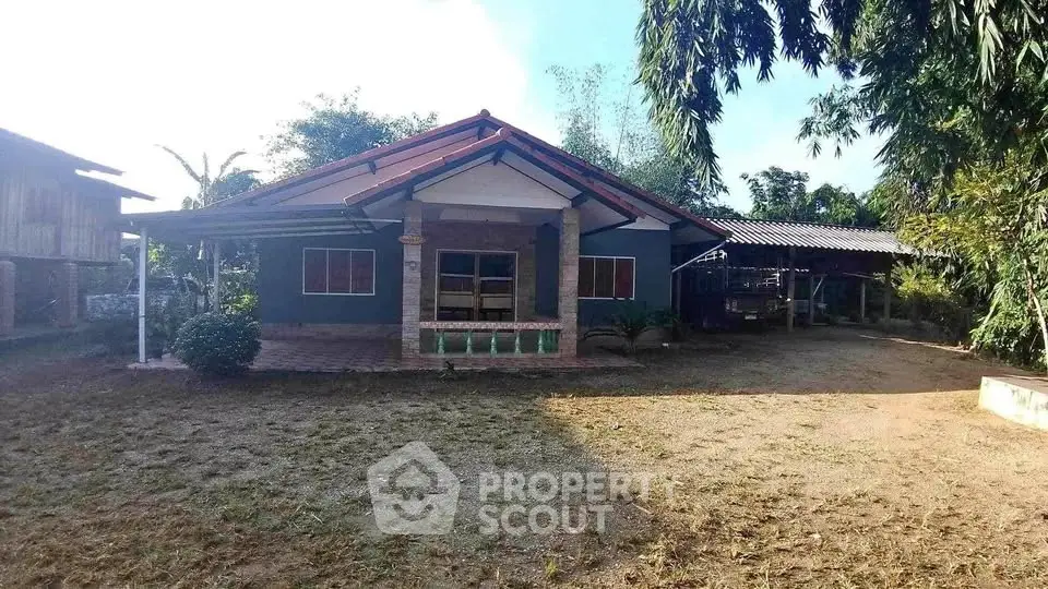 Charming rural house with spacious yard and traditional architecture, perfect for serene living.