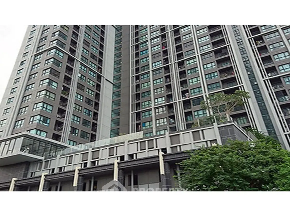 Modern high-rise building with sleek architecture and large windows in urban setting.