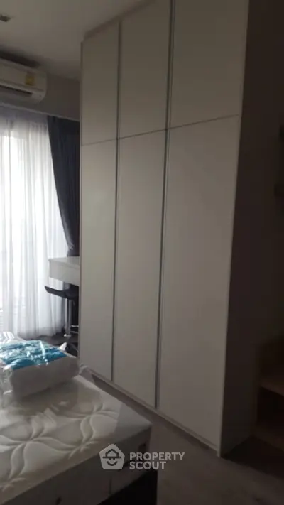 Modern bedroom with large wardrobe and natural light