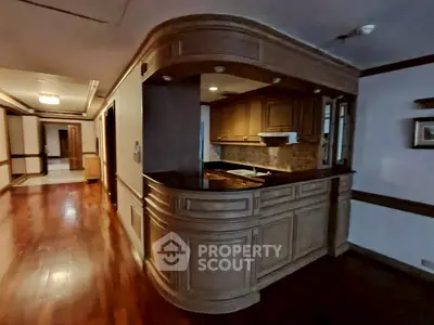 Elegant kitchen with wooden cabinetry and open layout in a luxurious home.