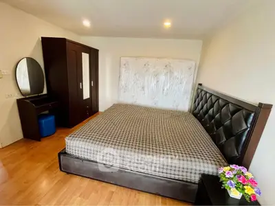 Spacious bedroom with elegant bed and wardrobe, perfect for comfort and style.