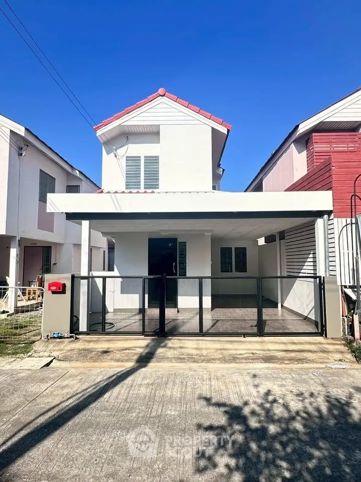 Charming two-story house with modern facade and spacious driveway
