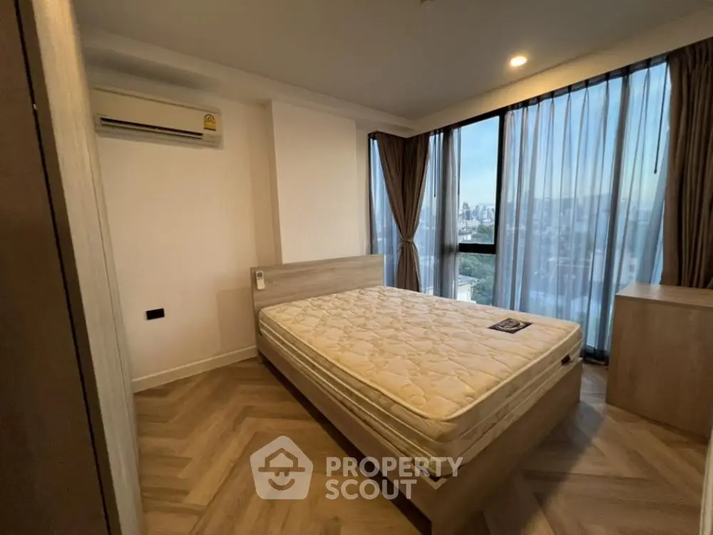 Spacious bedroom with city view and modern furnishings