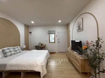 Modern bedroom with stylish decor and wooden flooring