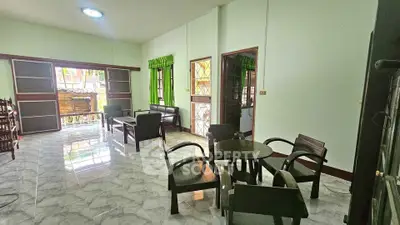 Spacious living room with elegant furniture and large windows for natural light.